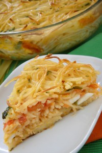 Piece of spaghetti pie with tomatoes and eggs